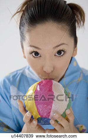 Stock Photo - Yukata woman who swells a paper balloon. Fotosearch