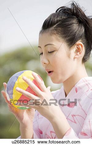 Yukata woman who swells a paper balloon View Large Photo Image Stock Photography - Yukata woman who swells a paper balloon. Fotosearch