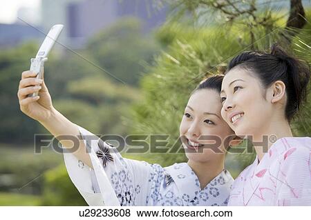 Yukata woman who takes a photograph View Large Photo Image Stock Photo - Yukata woman who takes a photograph. Fotosearch