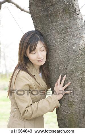Stock Image - Cherry tree and woman. Fotosearch