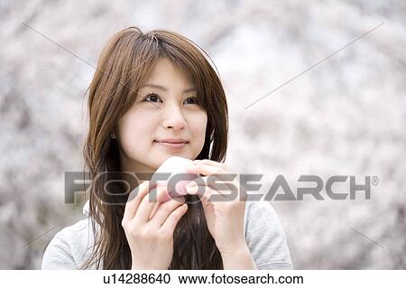 Stock Image - Cherry tree and woman. Fotosearch