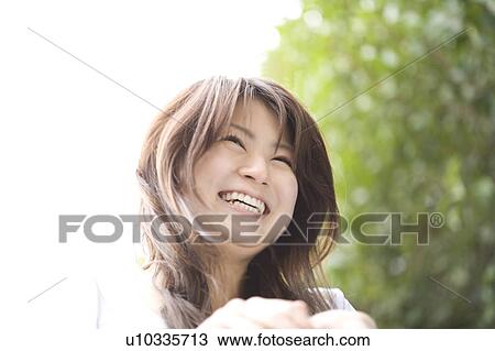 Stock Image - Woman under the cherry tree. Fotosearch