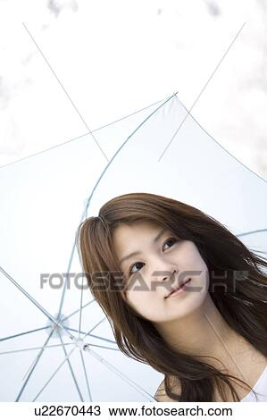 Stock Image - Woman under the cherry tree. Fotosearch