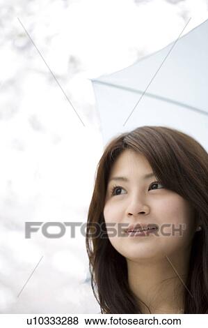 Stock Photo - Woman under the cherry tree. Fotosearch