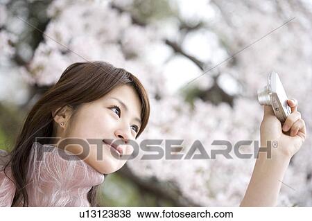 Woman under the cherry tree View Large Photo Image Stock Photo - Woman under the cherry tree. Fotosearch
