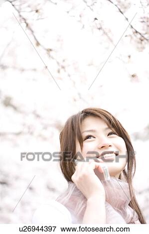 Woman under the cherry tree View Large Photo Image Stock Photo - Woman under the cherry tree. Fotosearch