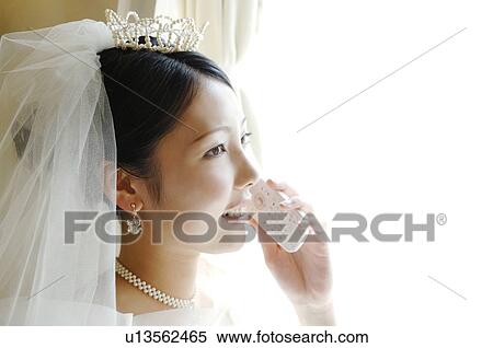 Bride talking with a cell phone View Large Photo Image Stock Photography - Bride talking with a cell phone. Fotosearch