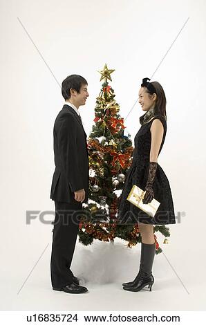 Picture - Couple exchanging Christmas present. Fotosearch