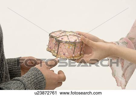 Stock Image - Couple exchanging Christmas present. Fotosearch