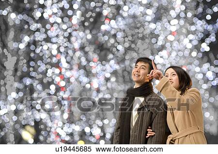 Stock Photography - Couple looking up. Fotosearch