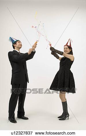Stock Photo - Couple pulling crackers. Fotosearch