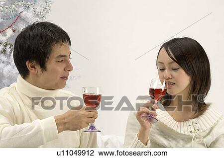 Stock Image - Couple toasting wine. Fotosearch