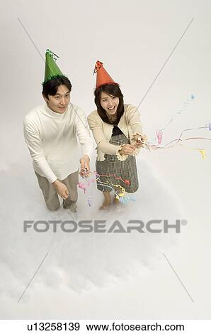 Couple wearing party hats View Large Photo Image Stock Photo - Couple wearing party hats. Fotosearch