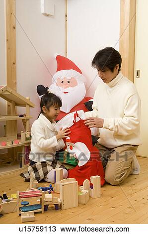 Daughter looking into Christmas stocking View Large Photo Image Stock Image - Daughter looking into Christmas stocking. Fotosearch
