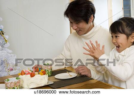 Stock Image - Family eating Christmas cake. Fotosearch