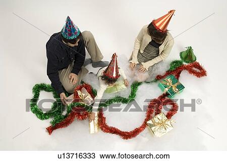 Family wearing party hats View Large Photo Image Stock Image - Family wearing party hats. Fotosearch