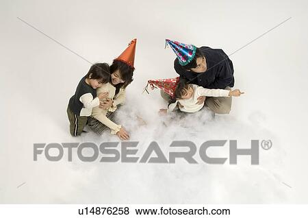Stock Photo - Family wearing party hats. Fotosearch
