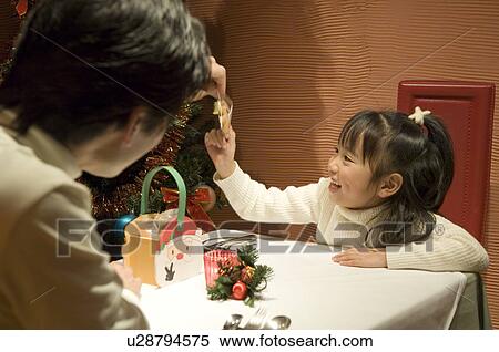 Father and daughter sitting at table View Large Photo Image Stock Photography - Father and daughter sitting at table. Fotosearch
