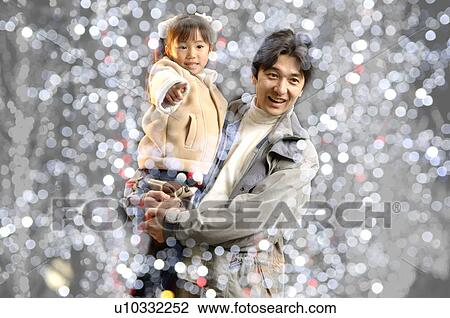 Stock Image - Father carrying daughter. Fotosearch