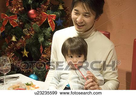 Father sitting with son on laps View Large Photo Image Stock Photo - Father sitting with son on laps. Fotosearch