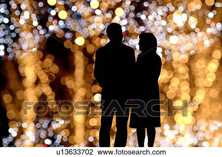 Rear view of couple standing View Large Photo Image Stock Image - Rear view of couple standing. Fotosearch