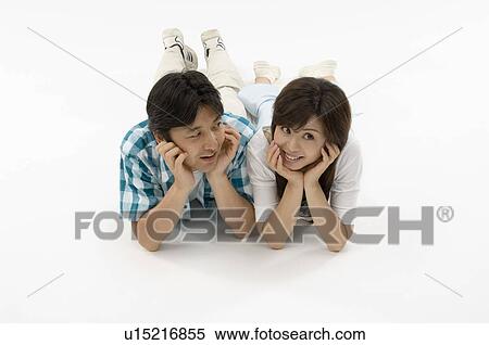 Stock Photography - Husband and wife lying on front. Fotosearch