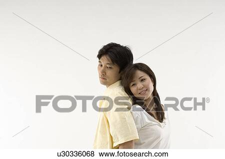 Husband and wife standing back to back View Large Photo Image Stock Photo - Husband and wife standing back to back. Fotosearch