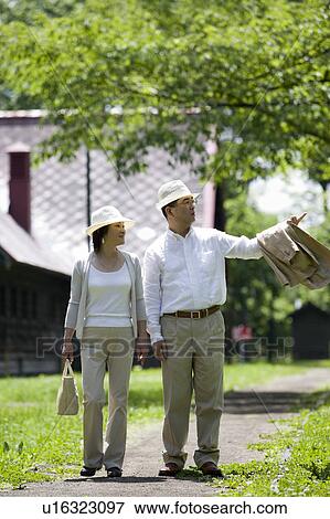 Mature couple walking in park View Large Photo Image Stock Photo - Mature couple walking in park. Fotosearch