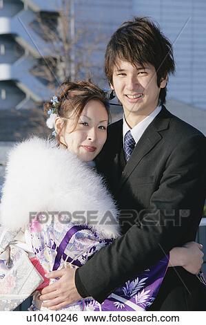 Stock Photograph - Portrait of young couple embracing. Fotosearch