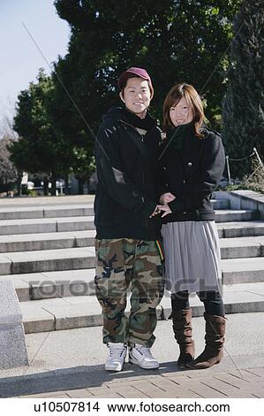 Portrait of young couple standing View Large Photo Image Picture - Portrait of young couple standing. Fotosearch