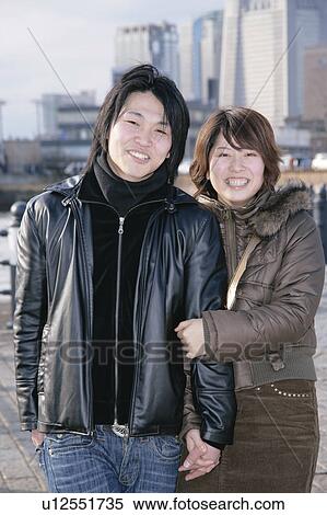 Portrait of young couple standing View Large Photo Image Stock Photography - Portrait of young couple standing. Fotosearch