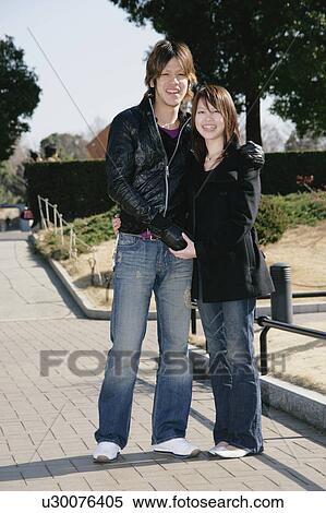 Portrait of young couple standing View Large Photo Image Stock Photography - Portrait of young couple standing. Fotosearch
