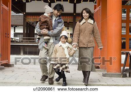 Stock Image - Family at shrine. Fotosearch