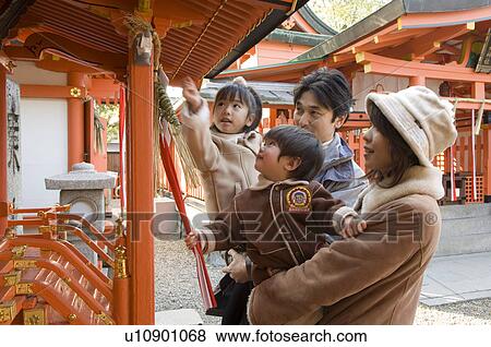 Stock Photo - Family at shrine. Fotosearch