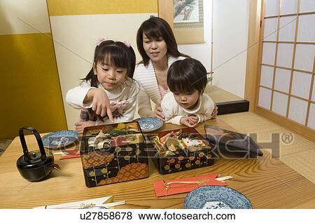 Stock Photo - Family eating New Year's Day meal. Fotosearch