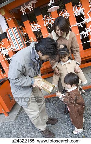 Stock Photography - Family getting fortune paper. Fotosearch
