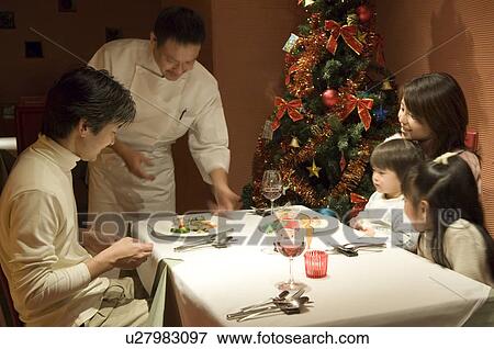 Family having Christmas dinner View Large Photo Image Stock Photo - Family having Christmas dinner. Fotosearch