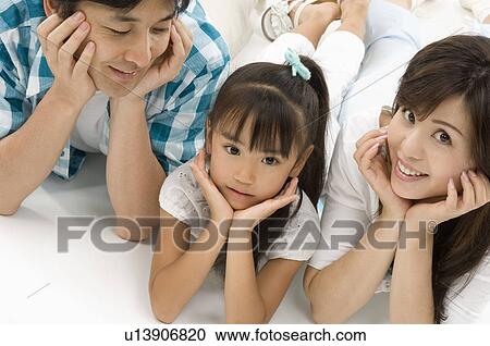 Family lying on front View Large Photo Image Stock Image - Family lying on front. Fotosearch