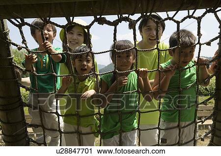 Stock Image - Family playing in playground. Fotosearch