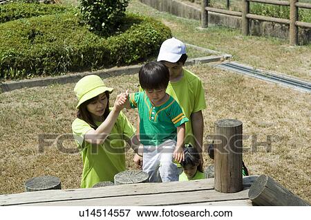 Stock Photo - Family playing in playground. Fotosearch