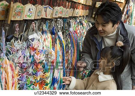 Stock Photo - Father and daughter at shrine. Fotosearch