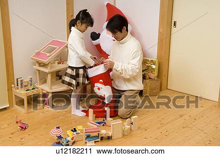 Father and daughter with Christmas stocking View Large Photo Image Stock Image - Father and daughter with Christmas stocking. Fotosearch