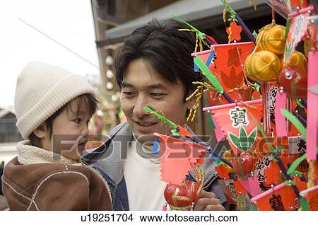Picture - Father carrying son. Fotosearch