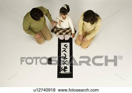 Stock Photo - Girl writing letters with ink brush. Fotosearch