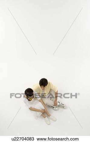 Stock Image - Husband and wife sitting and talking. Fotosearch