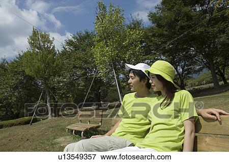 Husband and wife sitting on bench View Large Photo Image Stock Photo - Husband and wife sitting on bench. Fotosearch