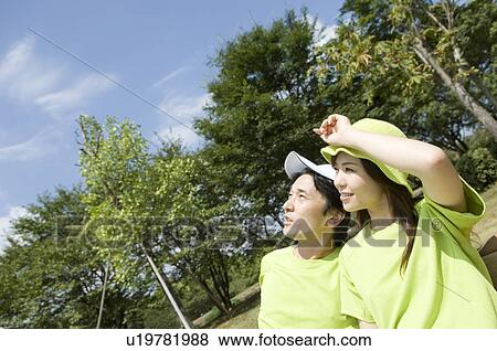 Stock Photo - Husband and wife sitting on bench. Fotosearch