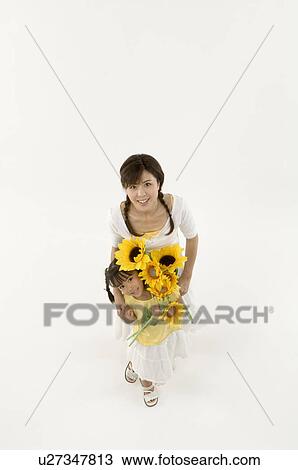 Mother and daughter holding sunflowers View Large Photo Image Stock Image - Mother and daughter holding sunflowers. Fotosearch