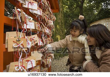 Mother and daughter looking at prayer blocks View Large Photo Image Stock Image - Mother and daughter looking at prayer blocks. Fotosearch