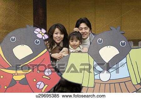 Stock Photography - Parents and daughter smiling. Fotosearch